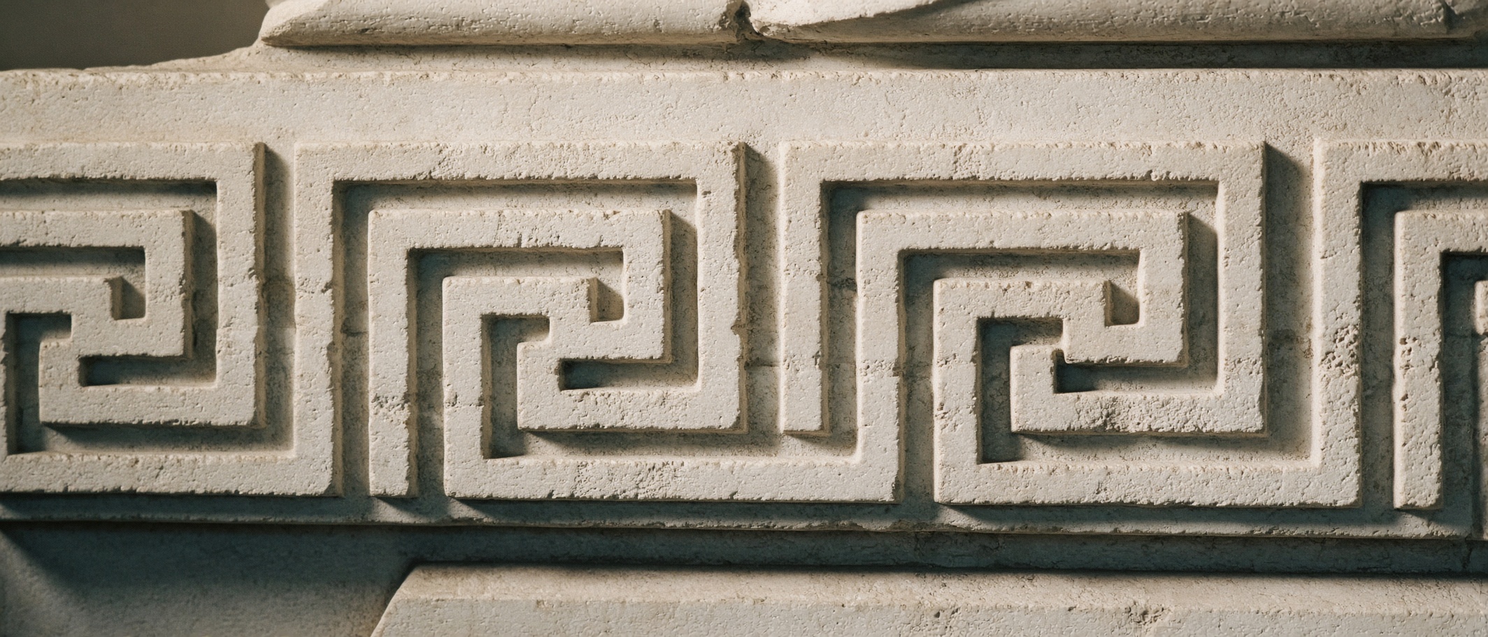 Carved Greek key pattern in pale limestone